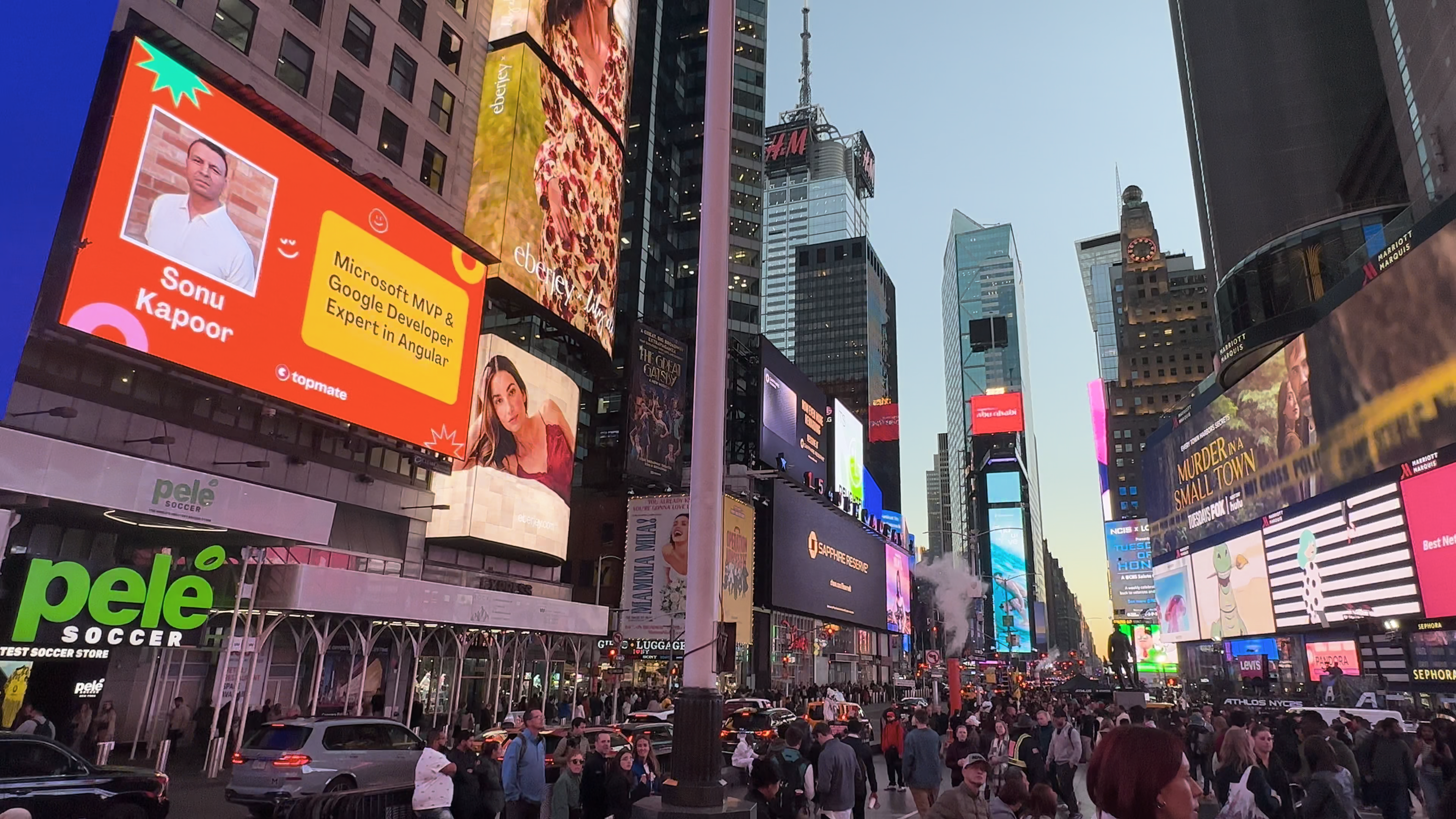 Wide view of Sonu Kapoor’s professional spotlight displayed on a Times Square billboard